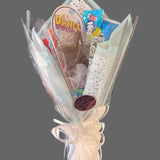 Wrapped  candy and chocolate in a bouquet. Designs may vary.